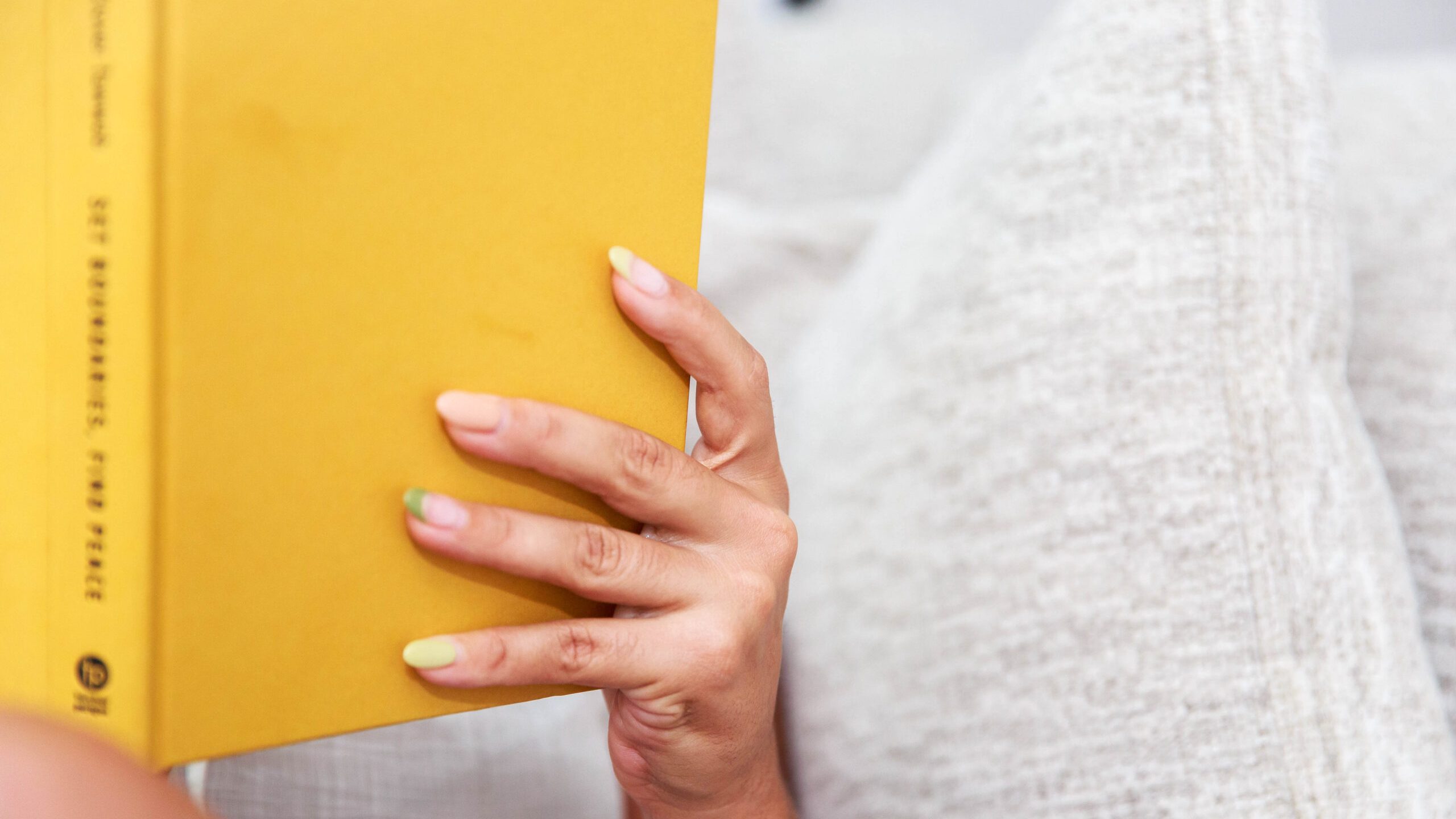 woman reading yellow book